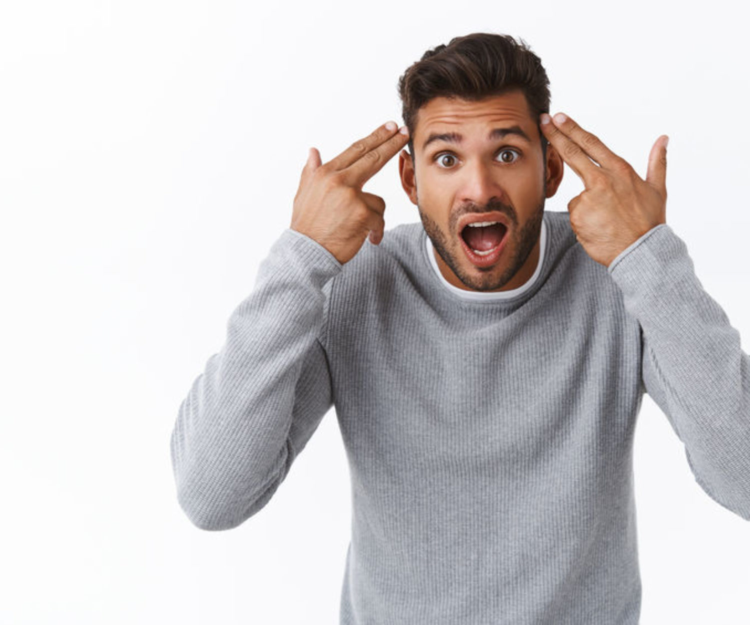 Are you crazy, out your mind. Annoyed and overreacting bothered handsome guy having argument with person making stupid dumb mistake, pointing temples and shouting at friend, quarreling.